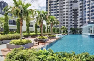 Swimming pool and palm trees at Southville City Cerrado residential suites, Sepang