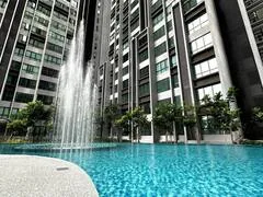 Swimming pool with water feature beside tall residential towers