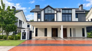 Semi-detached double-storey home with dark grey trim and red paved driveway in Setia Alam