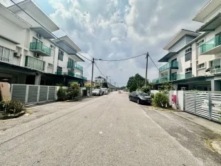 Street view of terraced houses along a quiet road at Desa Restu, Sepang