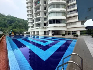 Swimming pool with geometric blue tiles and high-rise block at Taman Bucida Hijauan