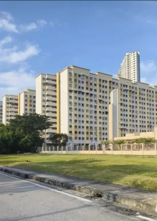 Exterior view of Pangsapuri Palm Court 2 blocks with fence and grass field