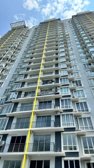 Facade of Residensi Seri Serindit high-rise tower with yellow lightning rod