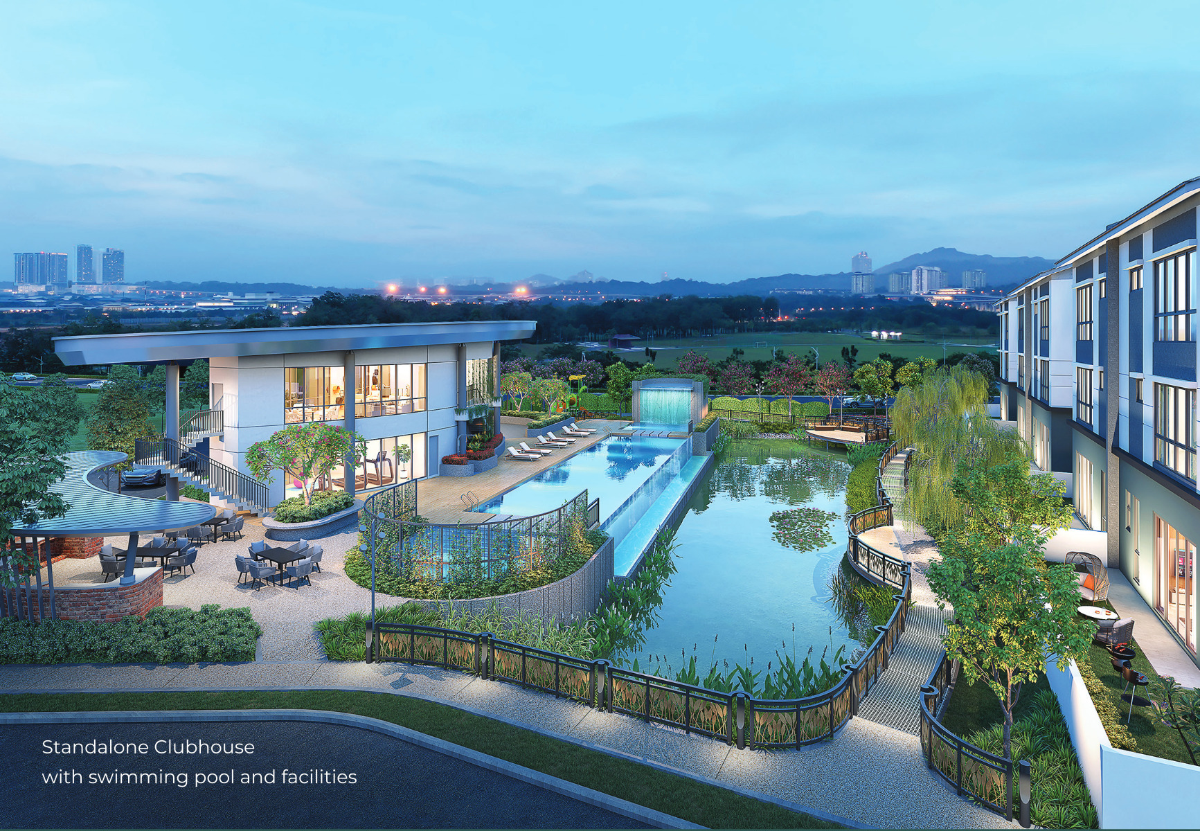 The standalone clubhouse at dusk — the infinity pool along the pond, the alfresco terrace under the canopy, and the town villas along the right-hand edge