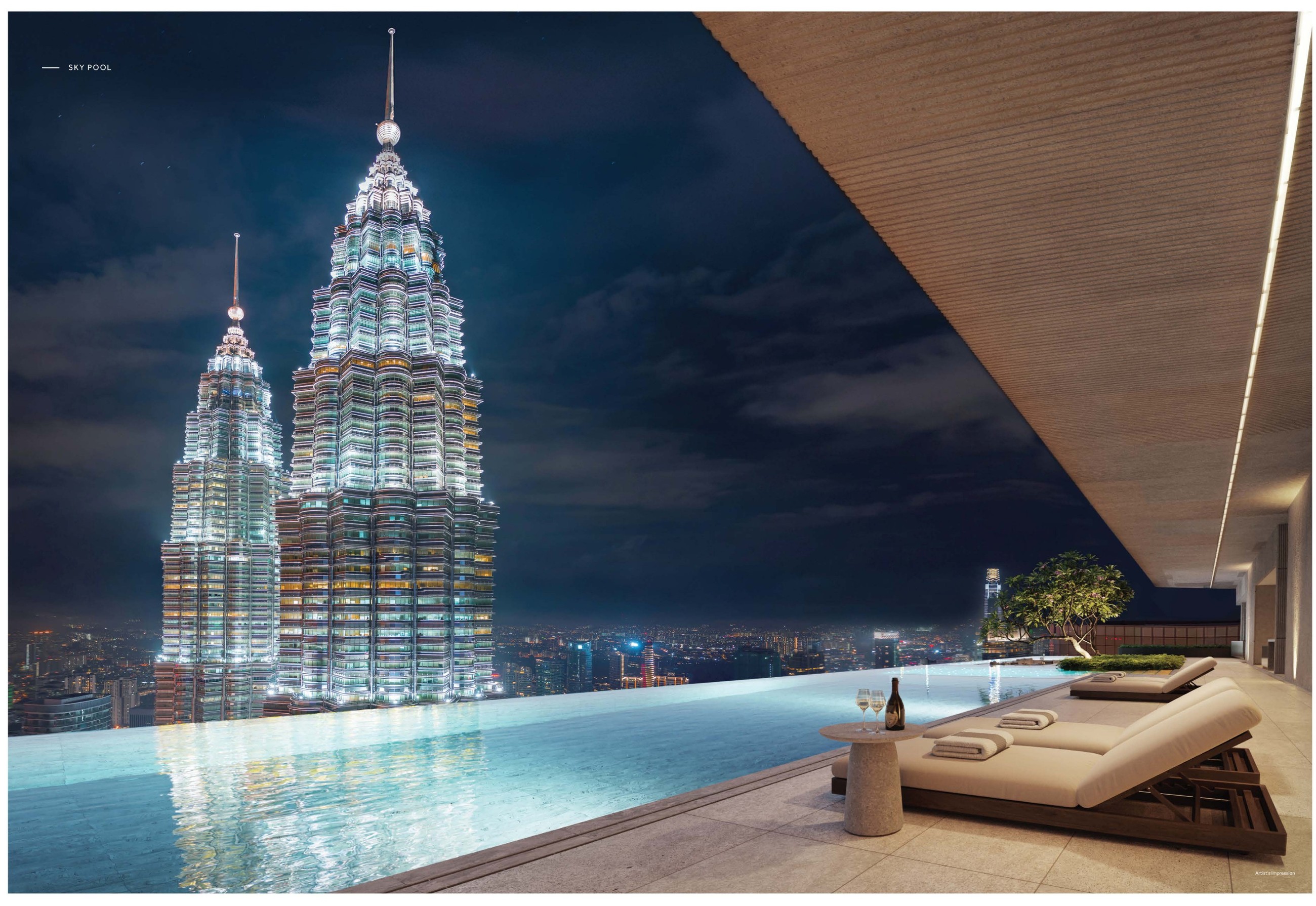 The sky pool — the infinity edge set against the illuminated Petronas Twin Towers, with the timber soffit overhead