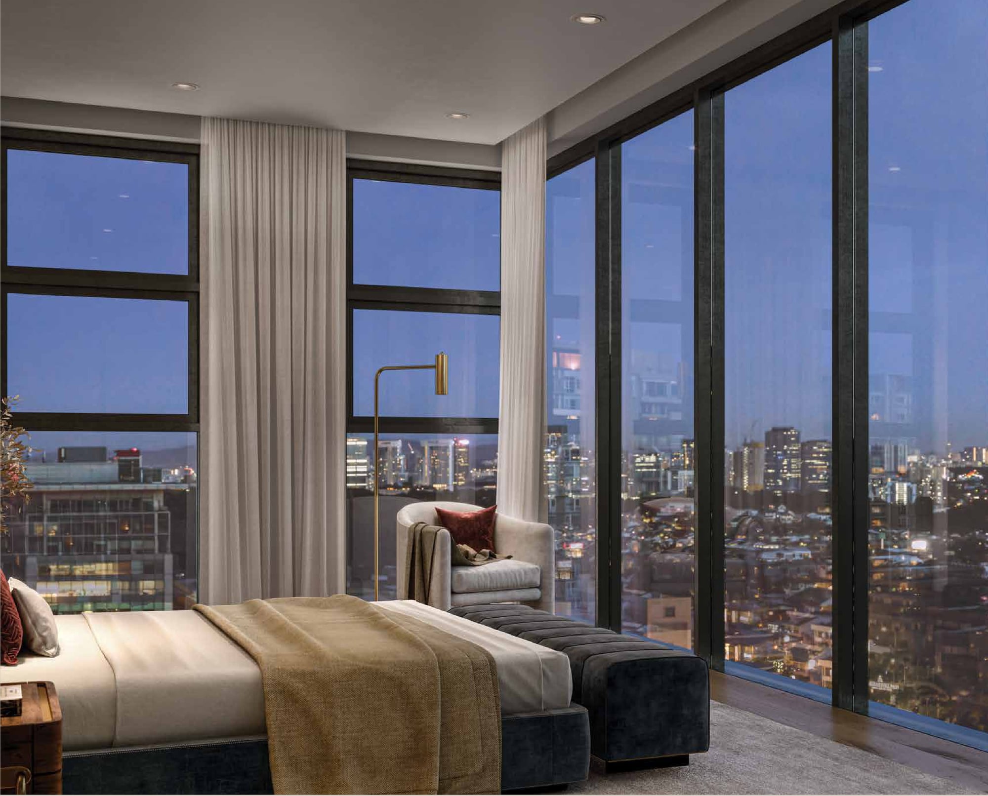 A bedroom at dusk with floor-to-ceiling glazing over the Bangsar rooftops