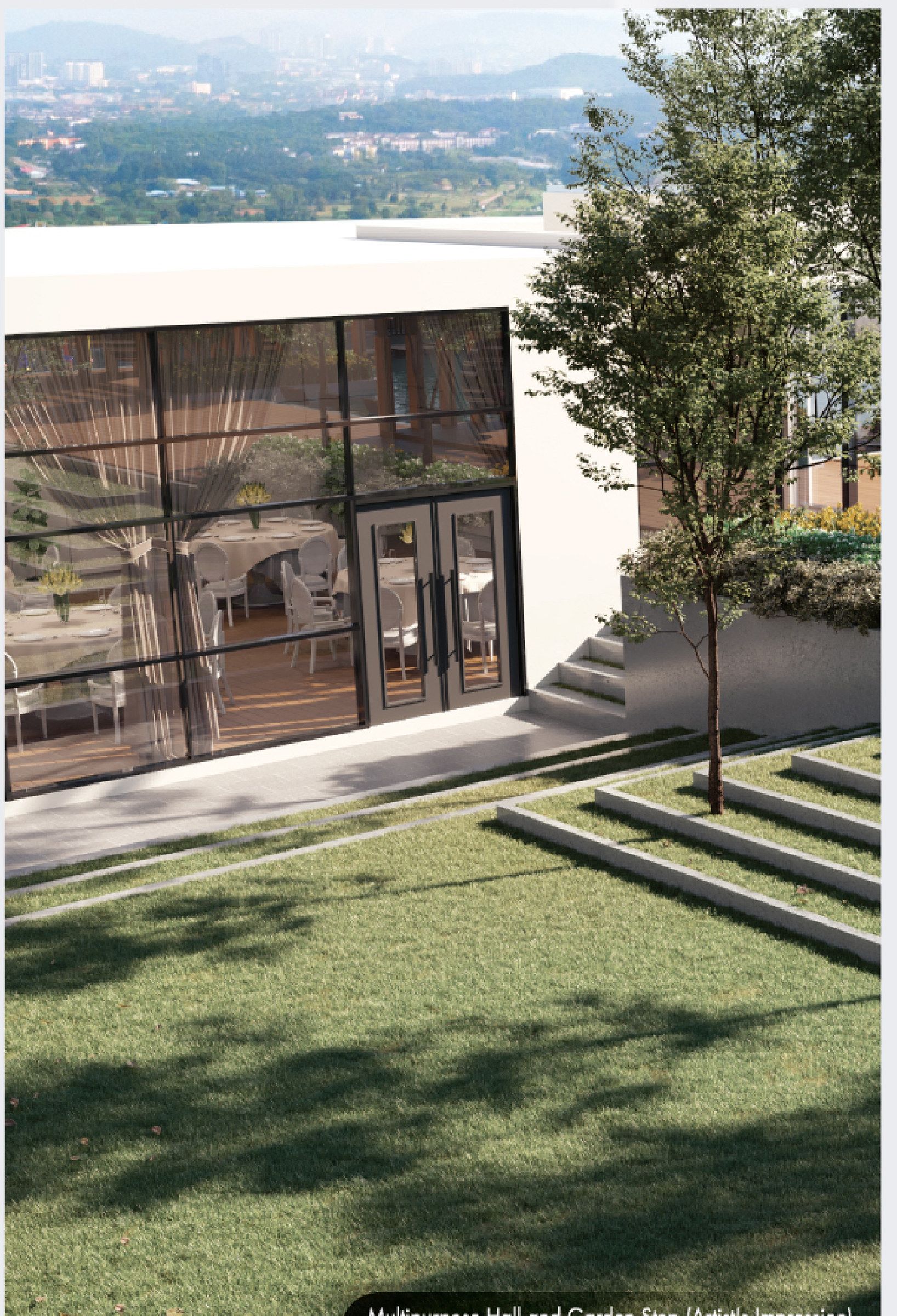 The multipurpose hall and the garden steps down to the open lawn, looking out over the valley